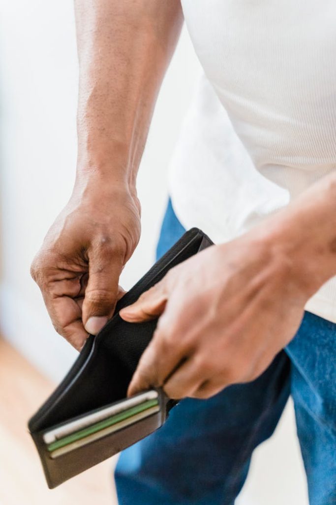 close-up-of-man-with-empty-wallet-7927422 Close-up shot of hands holding an empty wallet, symbolizing financial stress.